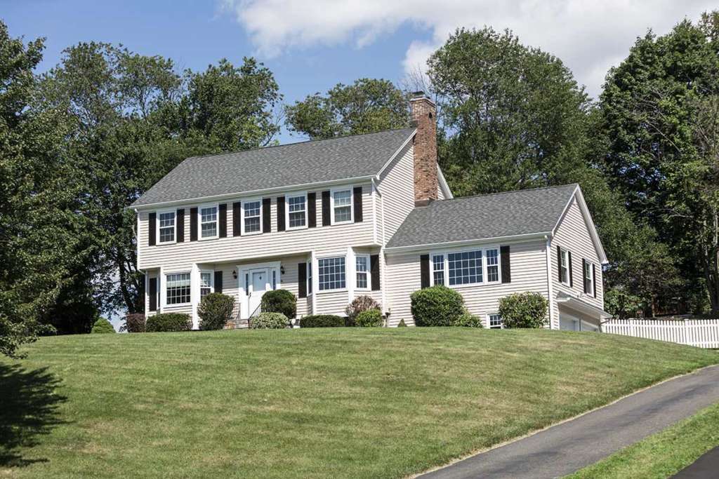 New england house on grassy hill